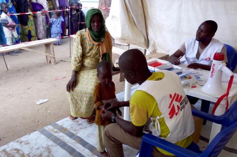 A malnourished child at a primary healthcare centre being observed by a specialist.