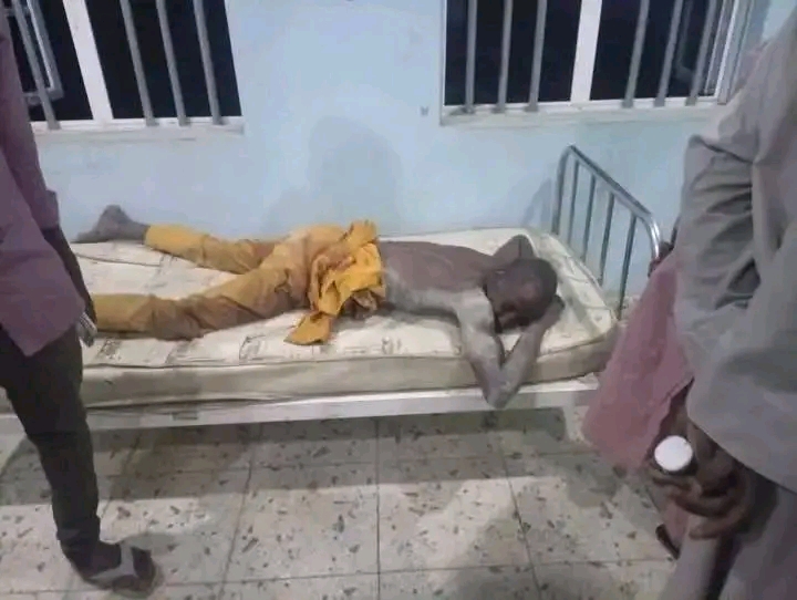 A male victim of the military air strike is lying in a hospital bed in a critical condition