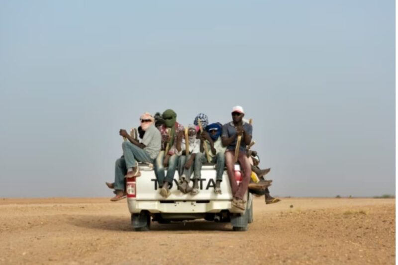 A migrant truck is in the middle of the Sahara, heading to North Africa.
