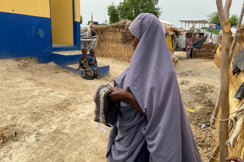 A displaced woman sewing caps to earn a living at the IDP. Photo credit: @Falmataaminamohammed